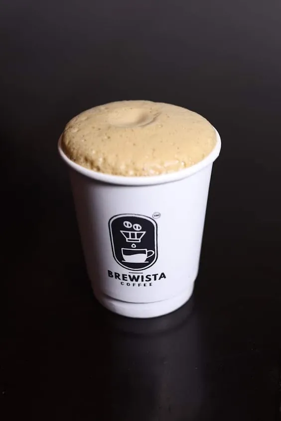 Barista pouring latte art with precision